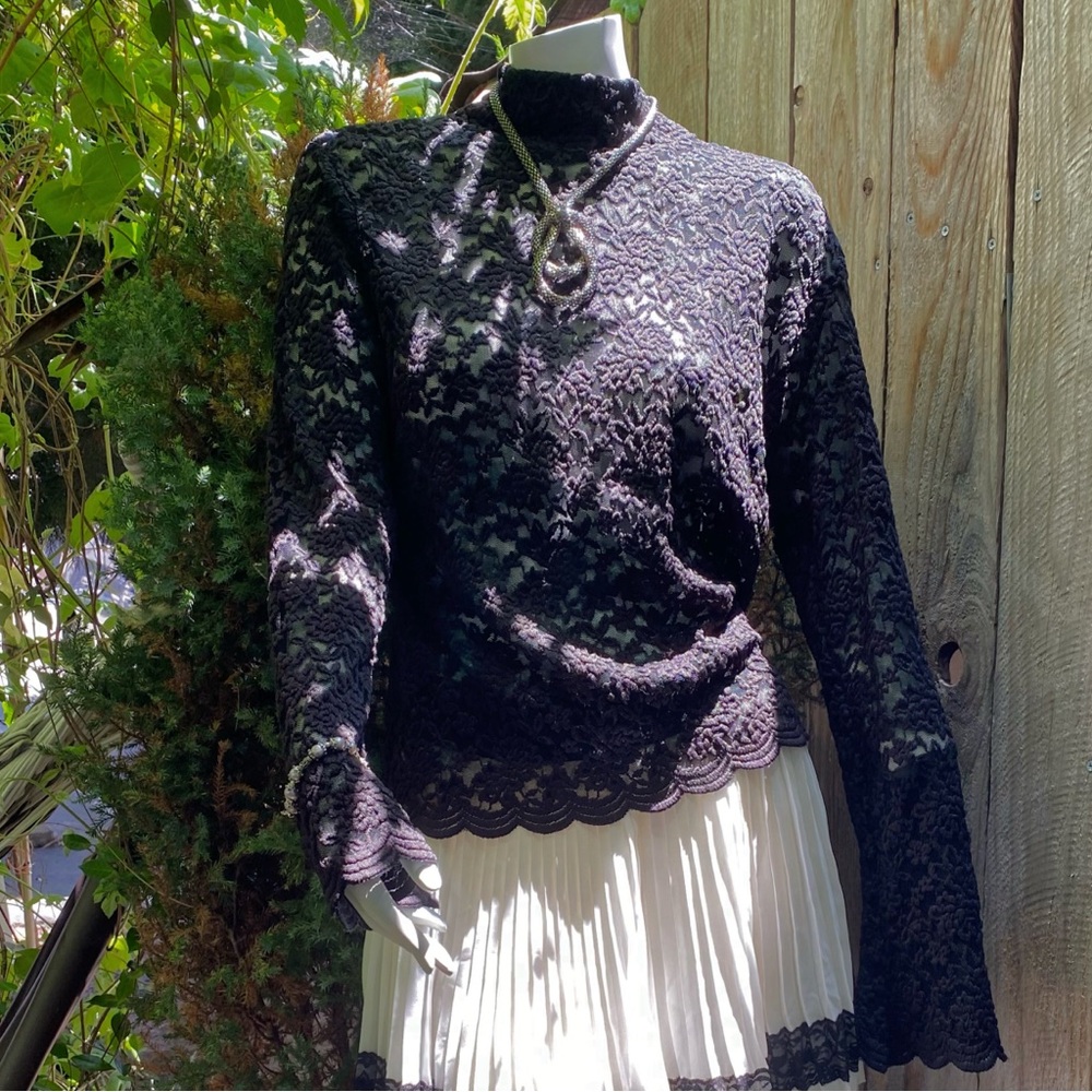 Black lace floral shirt 
Pleated white skirt with black lace